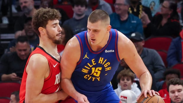 Nuggets center Nikola Jokic (15) dribbles against Houston Rockets center Alperen Sengun (28) in the first quarter at Toyota Center.